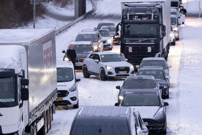 A number of trucks and cars are stuck on the E45 motorway near Randers in Jutland, Denmark, on January 4, 2024, after a heavy snowstorm has disturbed traffic and trapped road users due to the large amounts of snow. 