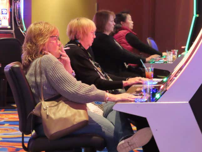 A gambler smokes while playing a slot machine at the Ocean Casino Resort on Wednesday, Nov. 29, 2023, in Atlantic City, N.J. On Thursday, Nov. 30, a bill to ban smoking in Atlantic City&#39;s nine casinos was not acted upon following a hearing that was widely expected to start the measure on its way to approval after nearly three years of inaction. (AP Photo/Wayne Parry)