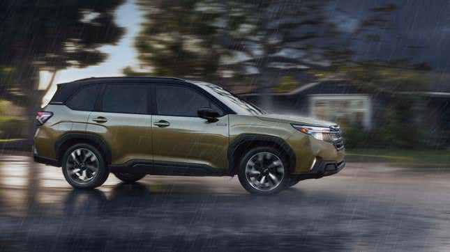 a side view of the green Forester Hybrid driving past a house in the rain