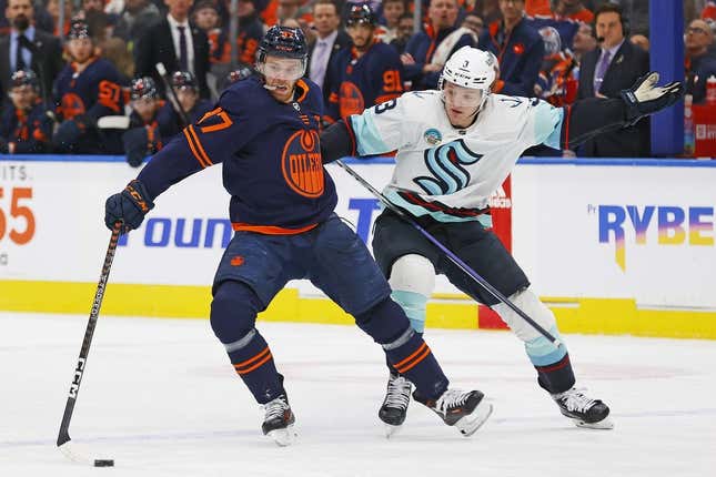 Jan 18, 2024; Edmonton, Alberta, CAN; Seattle Kraken defensemen Will Borgen (3) tries to pull Edmonton Oilers forward Connor McDavid (97) off the puck during the first period at Rogers Place.