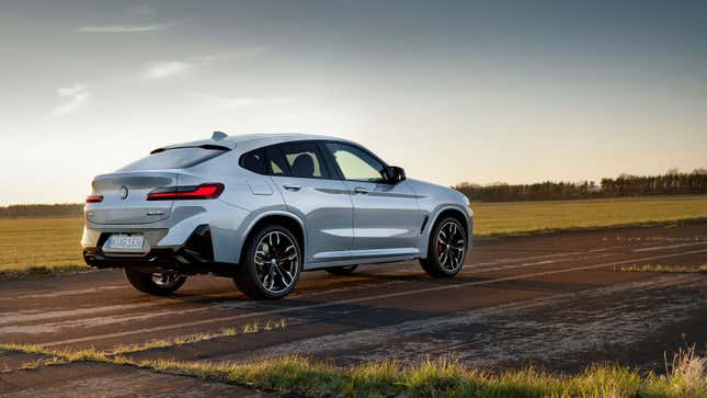 A photo of a white BMW X4 SUV parked on tarmac. 