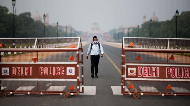 A man walks on a deserted street leading to the Presidential Palace during a government-imposed lockdown as a preventive measure against covid-19 in New Delhi, India, on March 24.