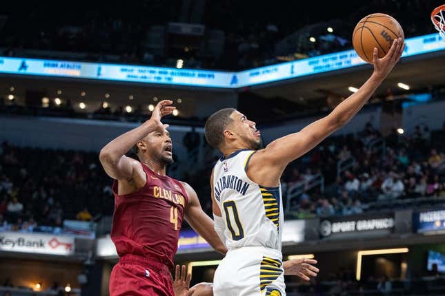 Oct 20, 2023; Indianapolis, Indiana, USA; Indiana Pacers guard Tyrese Haliburton (0) shoots the ball while Cleveland Cavaliers forward Evan Mobley (4) defends in the second half at Gainbridge Fieldhouse.