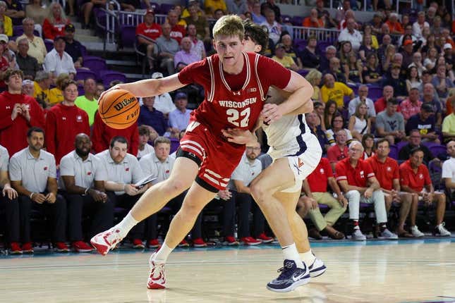 Nov 20, 2023; Fort Myers, Florida, USA;  Wisconsin Badgers forward Steven Crowl (22) drives to the basket past Virginia Cavaliers forward Blake Buchanan (0) in the second half during the Fort Myers Top-Off at Suncoast Credit Union Arena.
