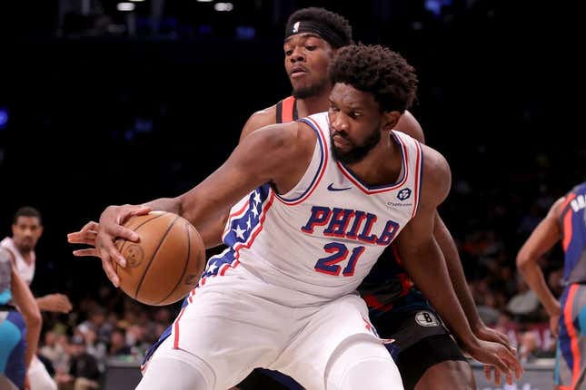 Nov 19, 2023; Brooklyn, New York, USA; Philadelphia 76ers center Joel Embiid (21) controls the ball against Brooklyn Nets center Day&#39;Ron Sharpe (20) during the second quarter at Barclays Center.