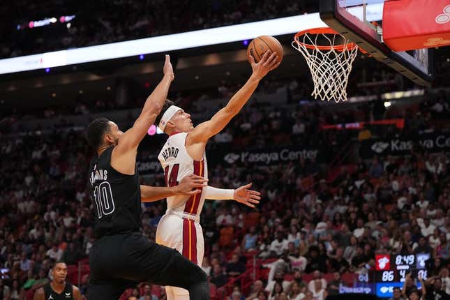 Nov 1, 2023; Miami, Florida, USA; Miami Heat guard Tyler Herro (14) shoots the ball around Brooklyn Nets guard Ben Simmons (10) during the second half at Kaseya Center.