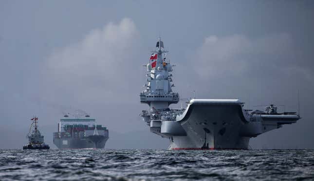 The Liaoning (right) arrives in Hong Kong on July 7.