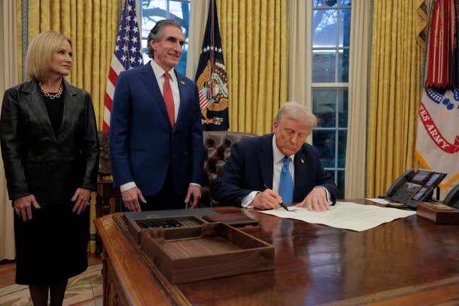 WASHINGTON, DC - JANUARY 31: U.S. President Donald Trump signs Interior Secretary Doug Burghum’s commission with Burgum and his wife Kathryn Burgum in the Oval Office on January 31, 2025 in Washington, DC. Trump spoke to reporters about tariffs against China, Canada and Mexico and how Burghum will coordinate with the Energy Department and the Environmental Protection Agency.