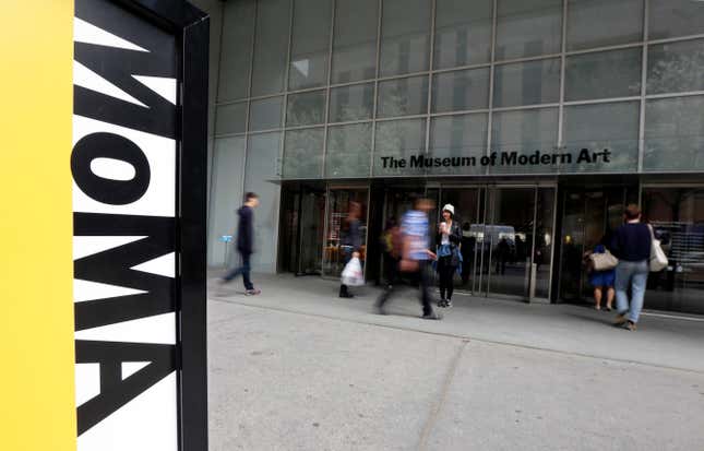 FILE - People walk by the entrance to the Museum of Modern Art, in New York, April 22, 2014. A performer who appeared naked in a show by world-renowned performance artist Marina Abramovic at the Museum of Modern Art is suing the museum, saying it failed to take action after he was sexually assaulted multiple times by attendees during the performances nearly 14 years ago. The suit was filed in Manhattan on Monday, Jan. 22, 2024 under the New York Adult Survivors Act, a special state law that created a yearslong suspension of the usual time limit for accusers to sue. (AP Photo/Richard Drew, file)