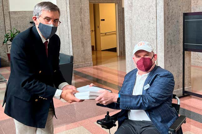 In this photo provided by I AM ALS, Dan Tate, right, delivers a printed petition from ALS patients and advocates to Dr. Peter Marks, left, director of the Food and Drug Administration&#39;s center for biologics at the FDA campus in Silver Spring, Md., on Dec. 14, 2022. The FDA meets this week to consider approval of an experimental treatment for Lou Gehrig’s disease, the culmination of a yearslong lobbying effort by patients with the fatal, neurodegenerative disease. Those advocates still face one giant hurdle: FDA regulators say the treatment hasn&#39;t been shown to work. In documents posted Monday, Sept. 25, 2023 the FDA reiterated its longstanding position: drugmaker Brainstorm&#39;s lone study doesn&#39;t provide clear evidence that its stem cell-based therapy helps patients with ALS, or amyotrophic lateral sclerosis. (Sonya Elling/I AM ALS via AP)