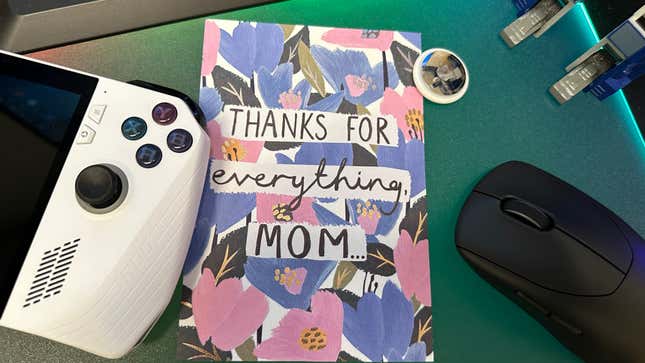 A mother's day card reading thanks for everything mom... alongside a Asus ROG Ally, a mouse, and an AirTag