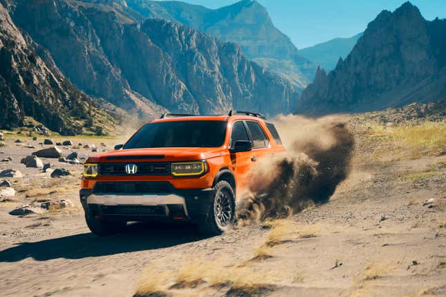 Front 3/4 view of an orange 2026 Honda Passport TrailSport drifting through sand