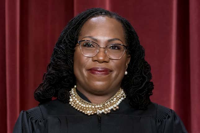 Associate Justice Ketanji Brown Jackson stands as she and members of the Supreme Court pose for a new group portrait following her addition, at the Supreme Court building in Washington, Friday, Oct. 7, 2022. 