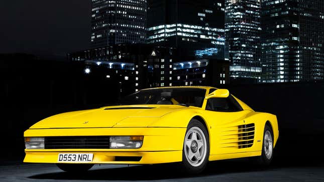 A photo of a yellow Ferrari Testarossa supercar. 