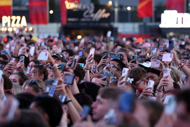 Festival goers hold up their smart phones to the stage during day two of Reading Festival 2024 at Richfield Avenue on August 24, 2024 in Reading, England.