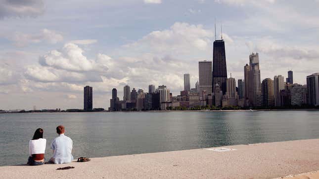 A photo of a couple looking out at the Chicago Skyline. 