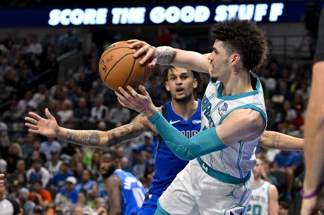 Nov 5, 2023; Dallas, Texas, USA; Charlotte Hornets guard LaMelo Ball (1) passes the ball past Dallas Mavericks center Dereck Lively II (2) during the second half at the American Airlines Center.