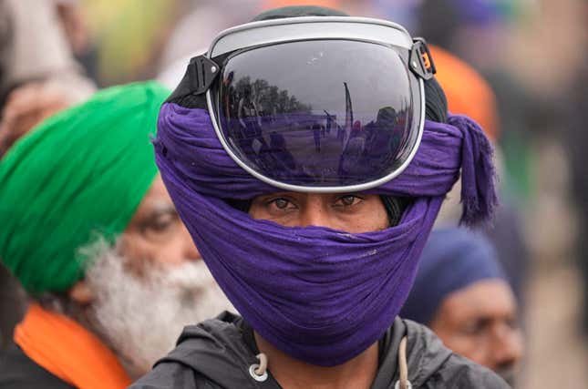 Indian farmers who have been protesting for a week to demand guaranteed crop prices wait to march to the capital near Shambhu border that divides northern Punjab and Haryana states, some 200 kilometers (120 miles) from New Delhi, India, Wednesday, Feb.21, 2024. The protesting farmers began their march last week, but their efforts to reach the city have been blocked by authorities. (AP Photo/Altaf Qadri)