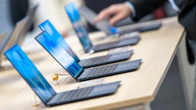 A photo of four laptops on display in a store. 