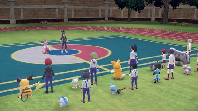 A group of students is seen with their partner Pokémon attending a class on Pokémon battling. The instructor is standing in the middle of a battle arena while the students listen from the sidelines.