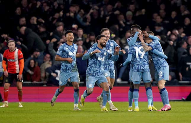 Aston Villa&#39;s Lucas Digne, right, is congratulated by his team mates after scoring his sides third goal during the English Premier League soccer match between Luton Town and Aston Villa at Kenilworth Road Stadium in Luton, England, Saturday, March 2, 2024. (Bradley Collyer/PA via AP)