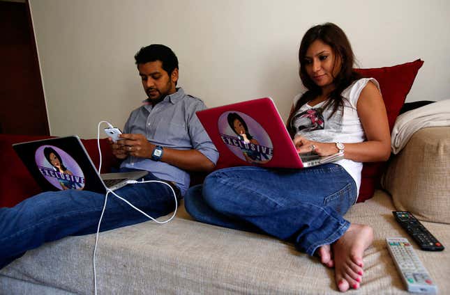 Malini Agarwal, blogger-in-chief of missmalini.com, and her husband Nowshad Rizwanullah sit on a couch as they blog from their living room in Mumbai