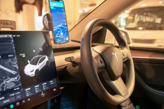 A photo of a phone on a phone stand inside of a Tesla