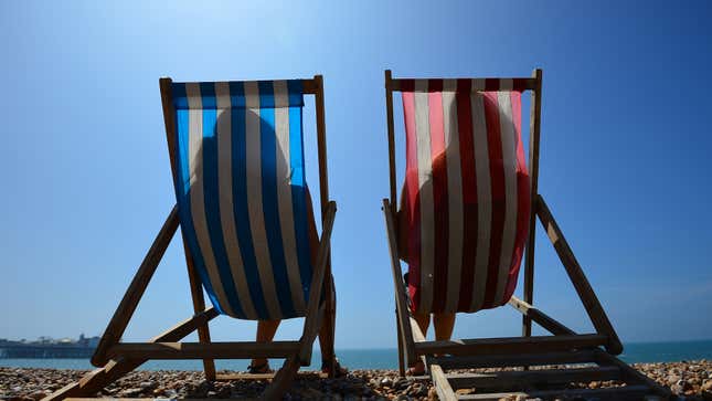 Two people relaxing on the beach during a hot summer day.