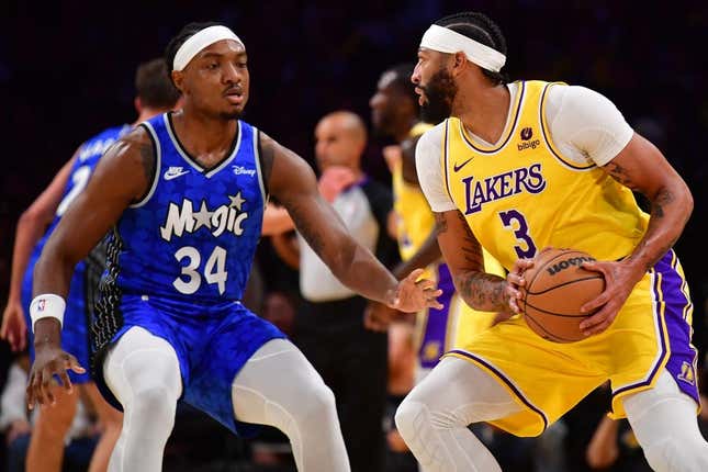 Oct 30, 2023; Los Angeles, California, USA; Los Angeles Lakers forward Anthony Davis (3) moves the ball against Orlando Magic center Wendell Carter Jr. (34) during the first half at Crypto.com Arena.