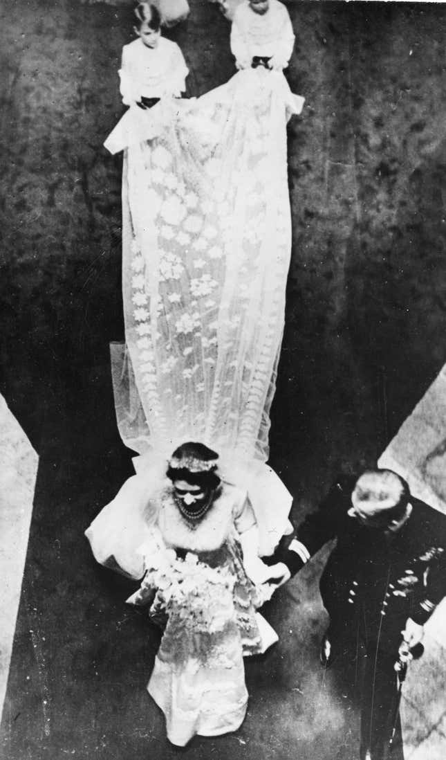Seen from above are the Royal newly-weds, British Princess Elizabeth and Lieutenant Philip Mountbatten (Duke of Edinburgh) as they leave Westminster Abbey, London, November 20, 1947. After their marriage, shows the bridal train. The 15-foot long bridal train is of transparent ivory silk, attached to the shoulders and edged with graduated satin flowers, finally forming a deep border encrusted with pearls and crystals. (AP Photo)