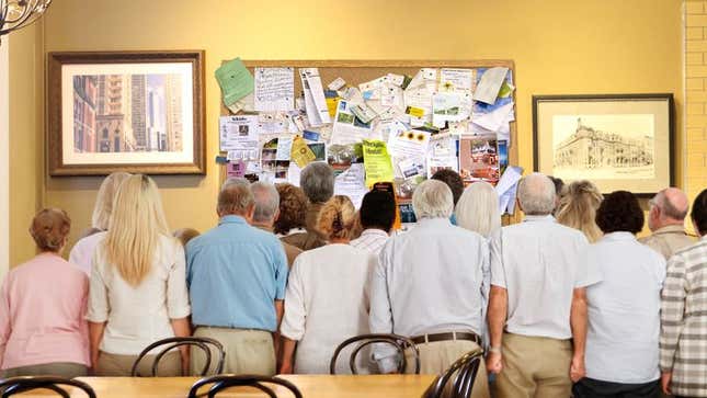Onlookers scramble to get a look at the freshly updated bulletin board.