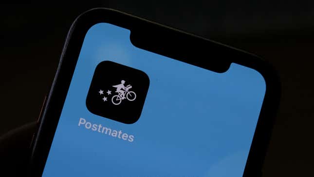This illustration photo taken on June 30, 2020 shows the logo of delivery app Postmates on a smartphone screen in Los Angeles.