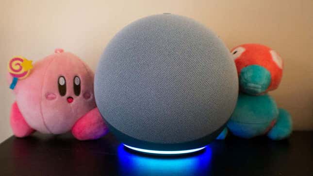 A photo of the 4th-gen Echo in front of a Kirby and a Porygon plush 