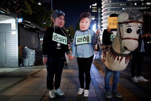 Protesters wearing cut-outs of Park Geun-hye, center, and Choi Soon-sil attended a protest in Seoul in October 2016.