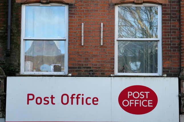 FILE = A post office logo on a shop front on a street in London, on Jan. 16, 2024. The British government will introduce legislation Wednesday, March 13, 2024, to quash the wrongful convictions of hundreds of Post Office branch managers in England and Wales who were caught up in one of the U.K.&#39;s biggest miscarriages of justice. Prime Minister Rishi Sunak said the legislation “marks an important step forward in finally clearing” the names of those who were convicted on the basis of a faulty computer accounting system, known as Horizon, and have faced long delays in having their compensation claims assessed. (AP Photo/Frank Augstein)