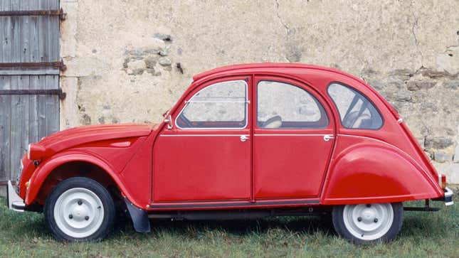 A photo of a red Citroen 2CV car. 