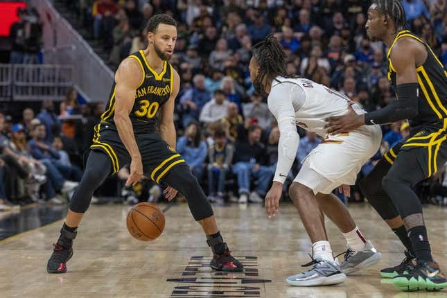 Nov 11, 2023; San Francisco, California, USA;  Golden State Warriors guard Stephen Curry (30) dribbles the basketball against Cleveland Cavaliers guard Darius Garland (10) during the fourth quarter at Chase Center.