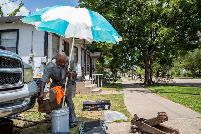  Community mechanic Lloyd Bush works on a neighbor’s vehicle during a heatwave on July 21, 2022, in Houston, Texas. Excessive heat warnings have been issued across Texas, with a predicted high of 102 degrees in Houston.