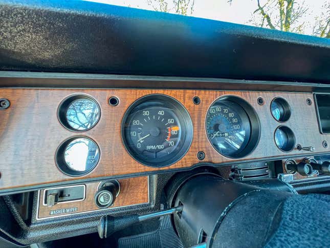 A close-up of the dashboard showing the gauges and the wooden dash panel