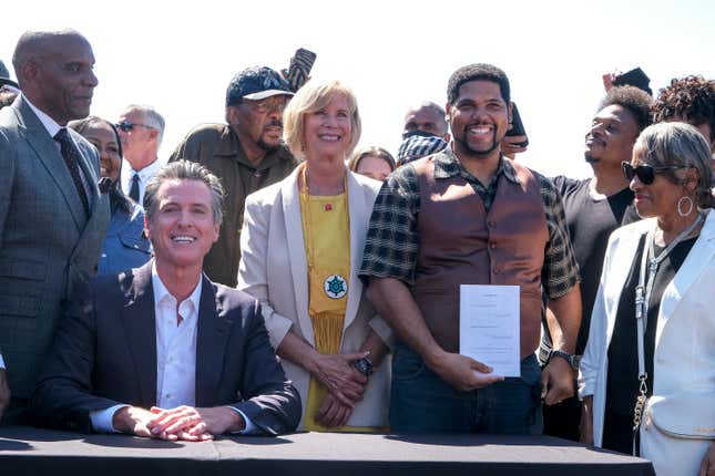 Anthony Bruce holds a bill “Bruce’s Beach Bill” after California Gov. Gavin Newsom signed it, Thursday, Sept. 30, 2021, in Manhattan Beach, Calif., that would help clear the way for Los Angeles County to return a piece of Manhattan Beach coastline to the descendants of a Black family who had the land stripped away by the city nearly a century ago.
