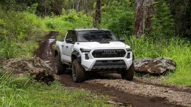 A white 2024 Toyota Tacoma on an unpaved trail 