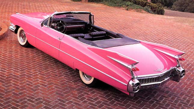 A photo of a pink convertible Cadillac. 