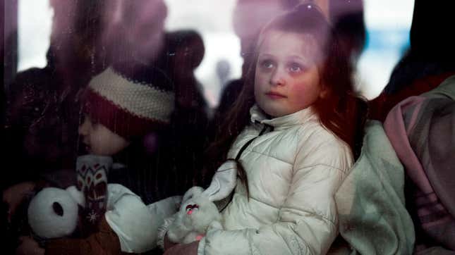 Ukrainian children wait in a bus after crossing the Ukrainian-Romanian border in Siret, northern Romania, on March 16, 2022. - More than three million people have fled Ukraine since the start of the invasion, the UN migration agency IOM says. Around half are minors, says the UN children's agency. (Photo by Armend NIMANI / AFP) (Photo by ARMEND NIMANI/AFP via Getty Images)