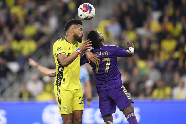 Nov 7, 2023; Nashville, Tennessee, USA; Nashville SC midfielder Anibal Godoy (20) heads the ball against Orlando City forward Ivan Angulo (77) in the second half at Geodis Park.