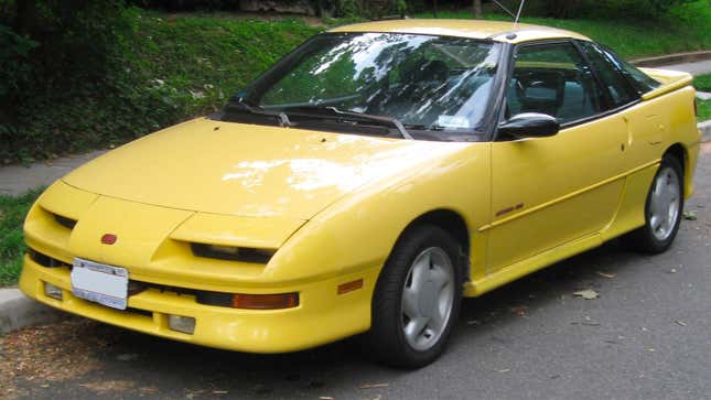 A yellow Geo Storm sedan. 