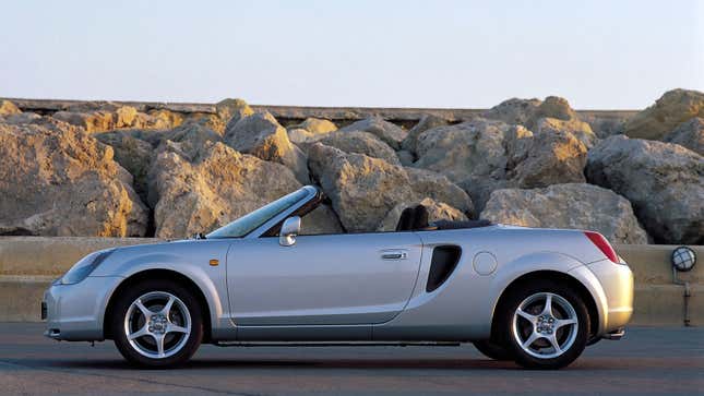 A photo of a silver Toyota MR2 sports car with its roof down. 