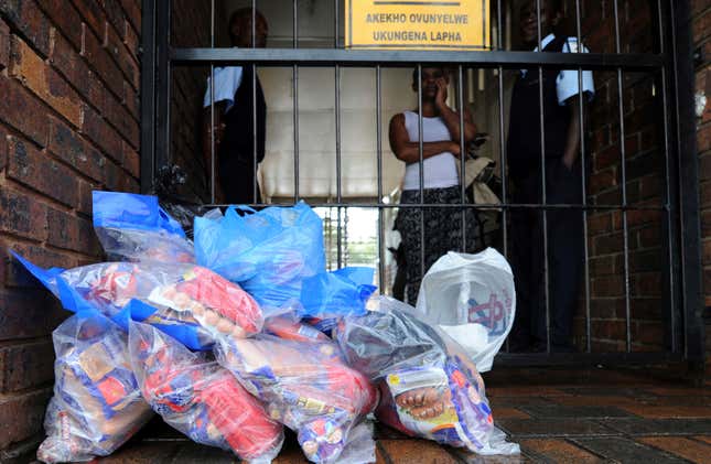 In this photo taken Monday March 5, 2018 a woman waits for a refund on returned processed foods at an outlet near Johannesburg. 