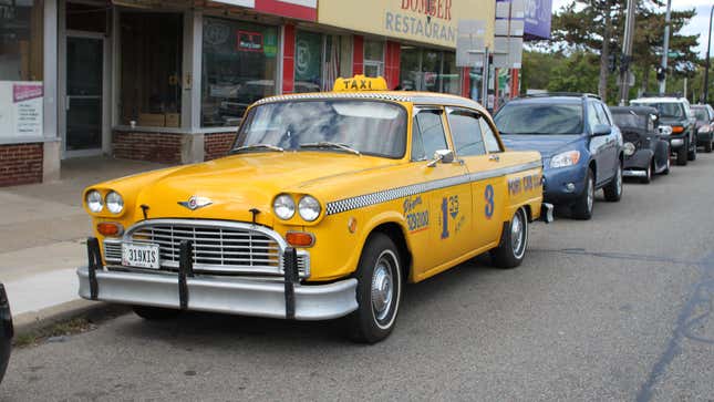 Vintage Checker cab in front of the Lucky Two Party Store, 308 East Michigan Avenue, Ypsilanti, Michigan.