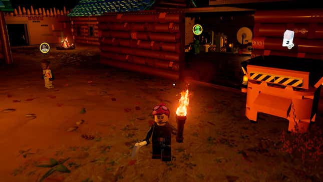 A minifig stands holding a torch in the desert.