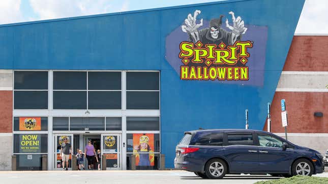 Spirit Halloween with a car parked in front